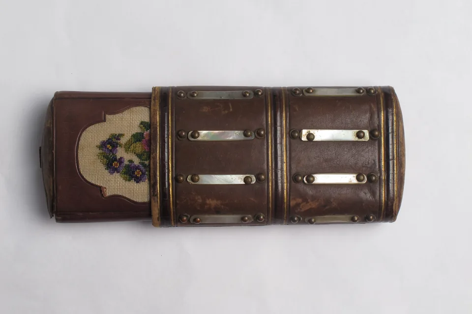 Choosing a Cigar Travel Case — antique leather cigar case with metal bands photographed on a plain background