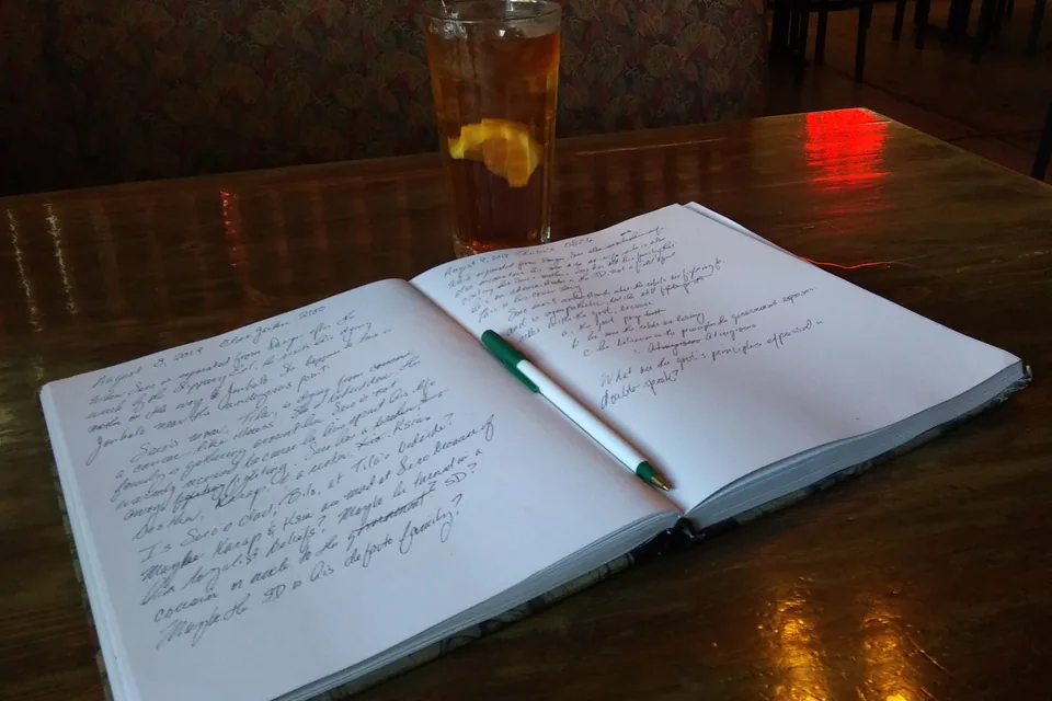 Davidoff Signature 2000 Review — open notebook filled with handwritten notes beside a drink on a dark bar table