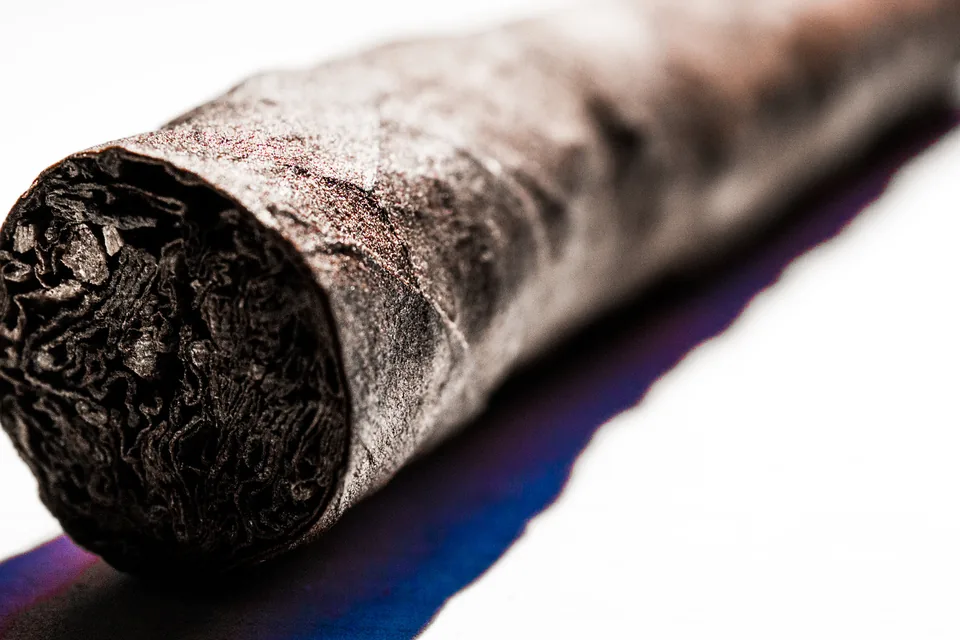 Cigars for Beginners: The Complete First-Cigar Guide — macro close-up of an unbranded cigar foot showing filler and dark wrapper texture