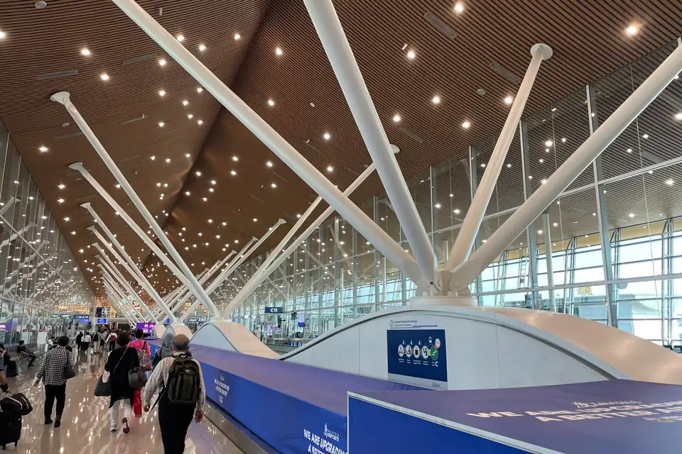 Bringing Cigars into Malaysia: The Malaysia Duty Free Allowance Explained — passengers walking through the timber-roofed main terminal hall at KLIA