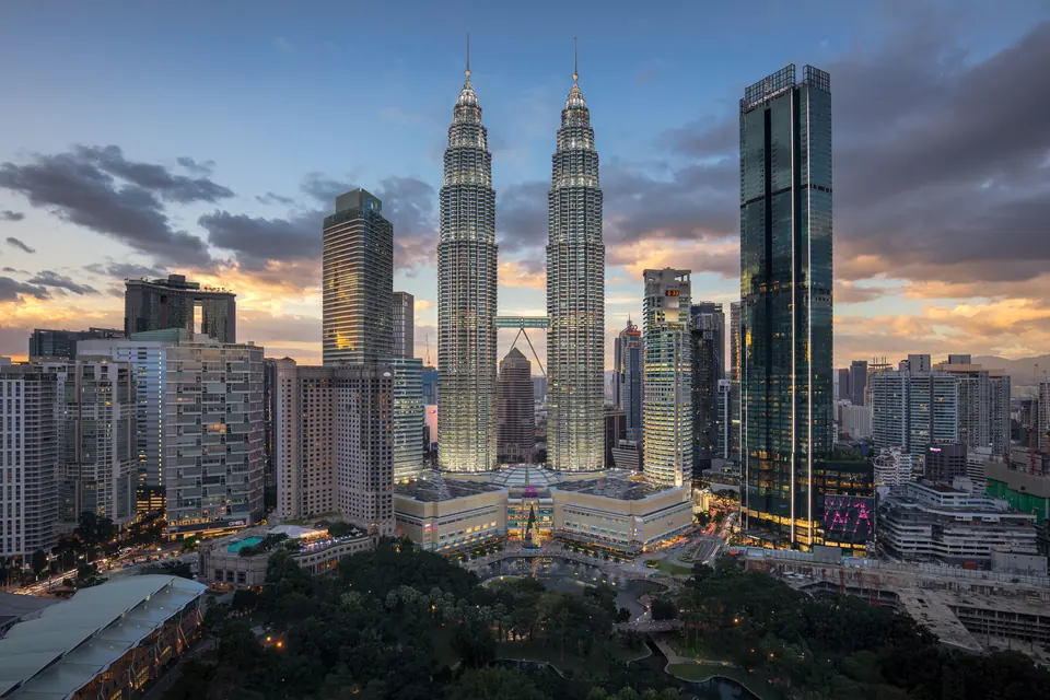 Cigars in Malaysia: The Complete Guide — kuala Lumpur skyline with Petronas Towers under a dramatic dusk sky